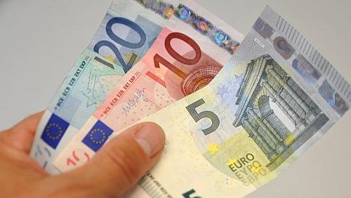 Hand mit Euro-Geldscheinen von 5, 10 und 20 Euro